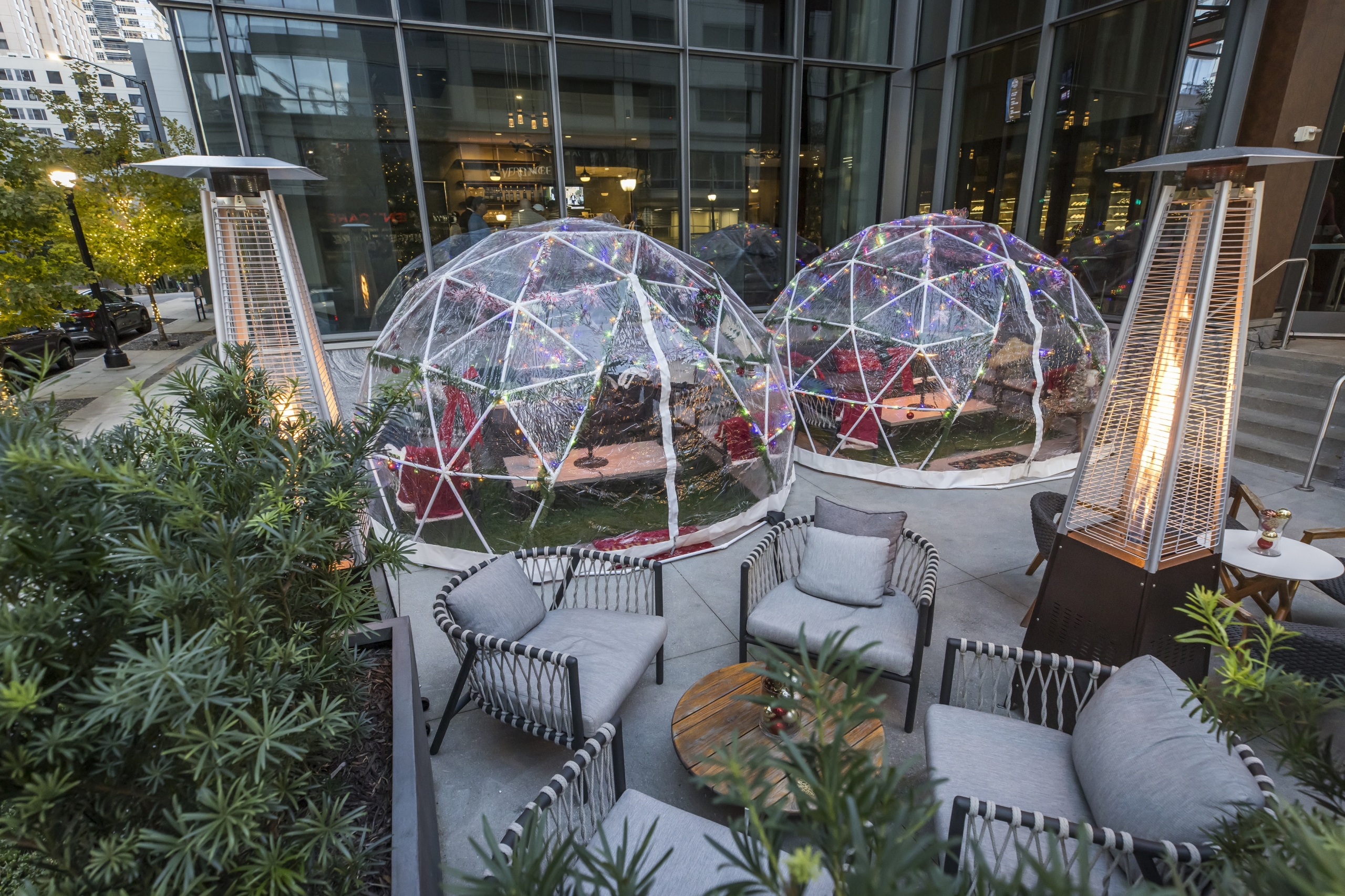an outdoor restaurant patio with two clear igloos for Reverence private dining at Epicurean Hotel in Midtown Atlanta
